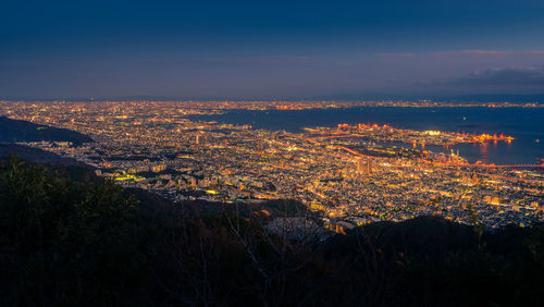 Aerial view of cityscape against sky at night