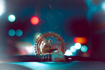 Close-up of illuminated lighting equipment on glass table