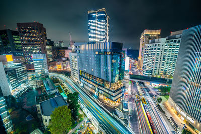 Aerial view of illuminated buildings in city at night