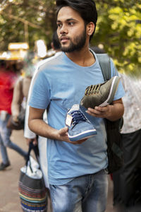 Man choosing shoes in market