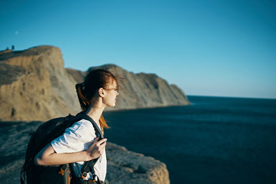 Man looking at sea against clear sky