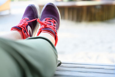 Low section of woman wearing canvas shoes