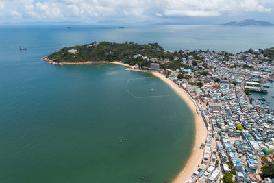 High angle view of sea and buildings against sky