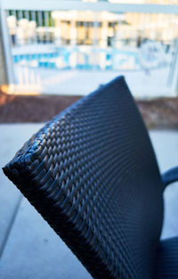 Close-up of camera on table by swimming pool