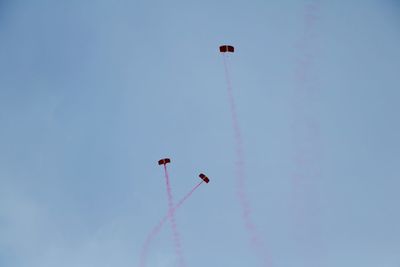 Low angle view of airshow against sky