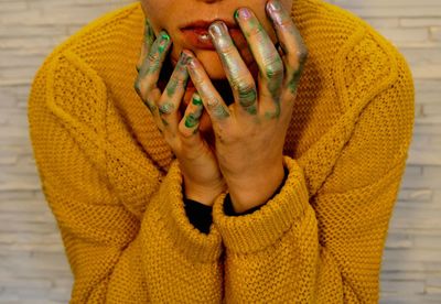 Midsection of woman with paint on hands