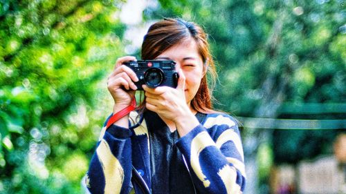 Portrait of woman photographing