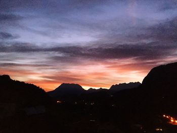 Scenic view of silhouette mountains against dramatic sky