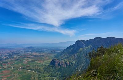 Scenic view of mountains against blue sky