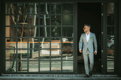 Man looking through window