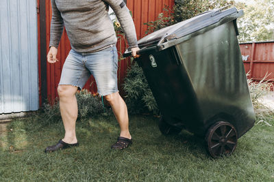 Low section of man standing on grass