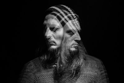 Portrait of man against black background