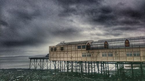 Built structure against cloudy sky at dusk