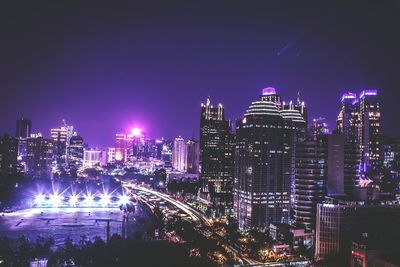 High angle view of city lit up at night