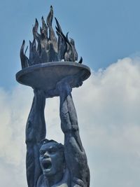 Low angle view of statue against sky