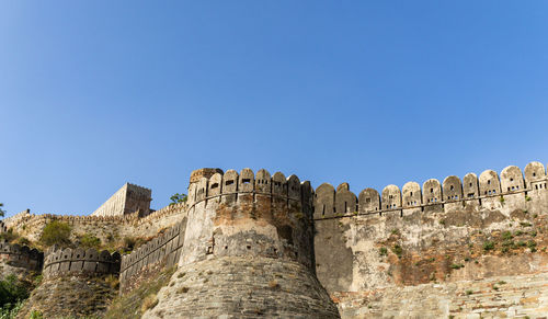 Ancient fort exterior wall ruins with bright blue sky at morning