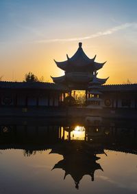 Silhouette of building against sky during sunset