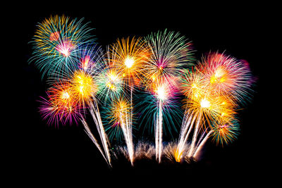 Low angle view of firework display against sky at night