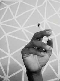 Midsection of person holding umbrella on tiled floor