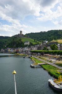 River by townscape against sky