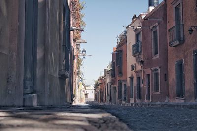 View of canal amidst buildings against sky