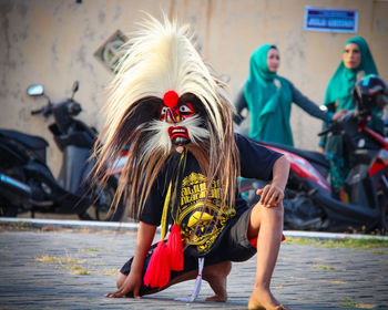 Woman with arms raised against people