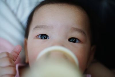 Close-up of baby girl having food