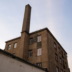 Low angle view of factory against sky