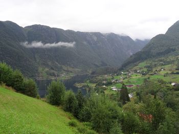 Scenic view of valley and mountains against sky