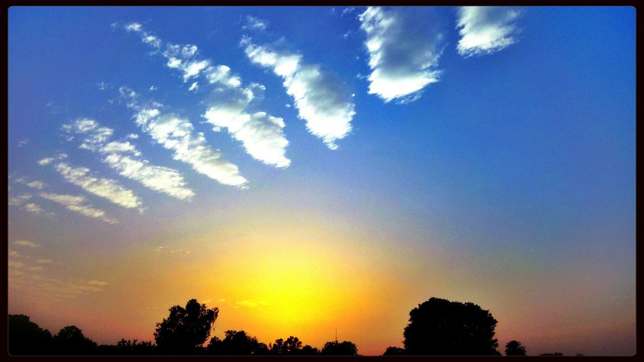 transfer print, silhouette, sky, sunset, beauty in nature, tranquility, tranquil scene, auto post production filter, scenics, low angle view, tree, cloud - sky, nature, cloud, blue, idyllic, outdoors, no people, sunlight, landscape