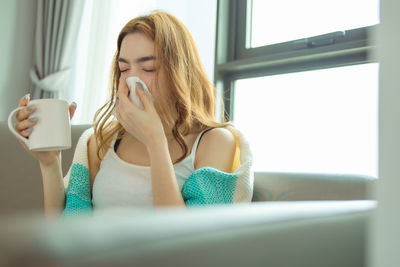 Young woman drinking coffee cup