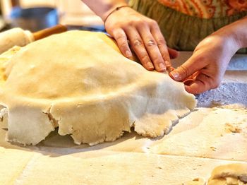 Close-up of person preparing homemade apple pie for holiday meal