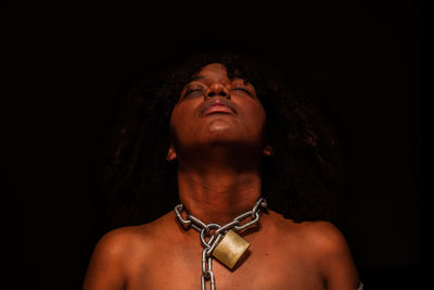 Low angle view of young man against black background