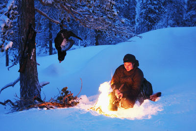 Hunter having fire at dusk