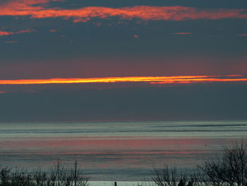 Scenic view of sea against romantic sky at sunset