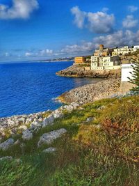 View of fort on sea against cloudy sky