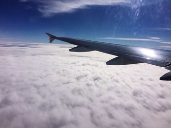 Cropped image of airplane flying in sky