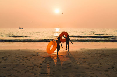 Children on beach at sunset