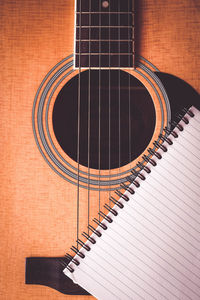 Directly above shot of note pad on guitar