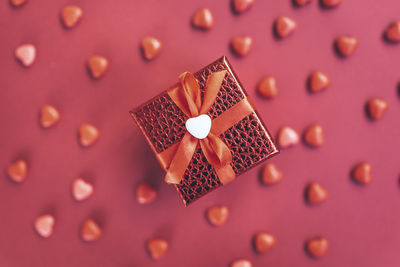 Red gift box on the background of hearts for valentine's day