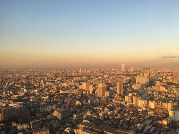 Aerial view of cityscape against clear sky