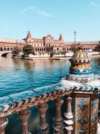 View of buildings by river in city