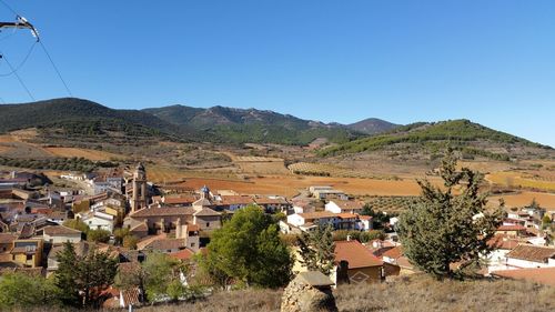 Town against clear blue sky