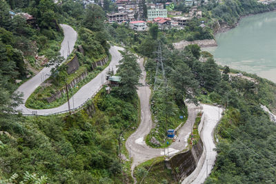 High angle view of road amidst trees in city