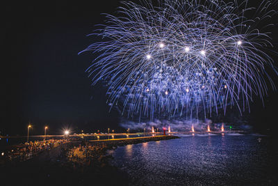 Low angle view of firework display at night