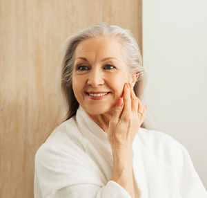 Portrait of young woman against white background