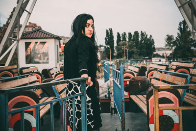 Portrait of young woman standing on ferry boat