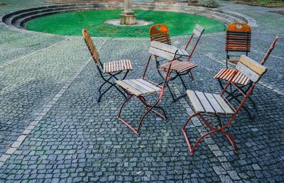 High angle view of chairs on table by swimming pool