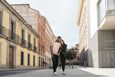 Couple standing on road in city