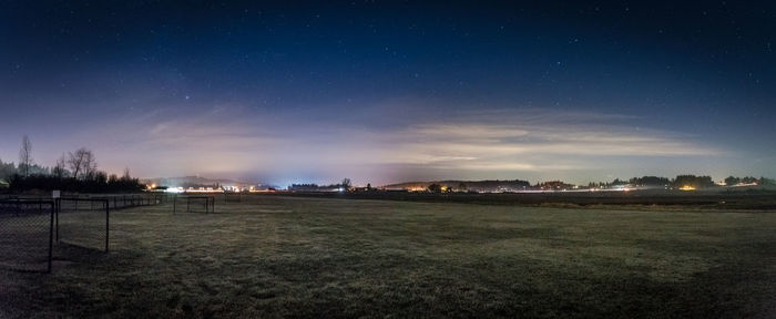 Scenic view of field against sky at night